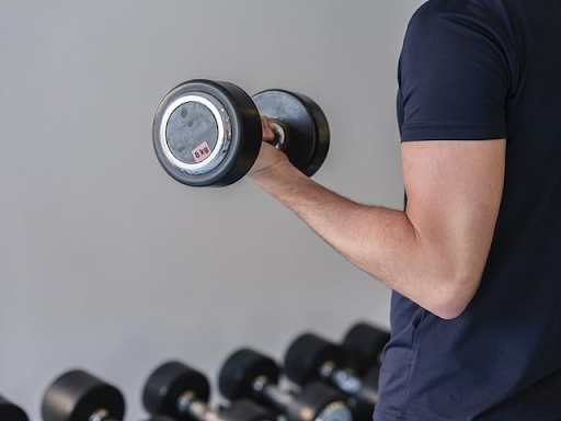 Man holding dumbell representing strength in hypermobility